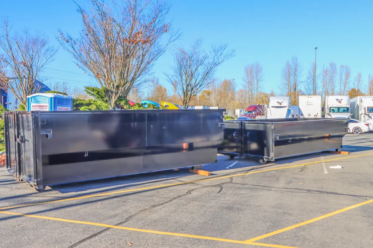 Professional dumpster rental service with roll-off container on residential driveway in Boulder City